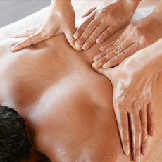 massage specialist is performing four hand massage therapy at DHA massage near me